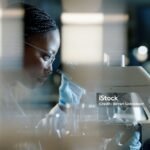 "Female scientist using a microscope in a laboratory for research"