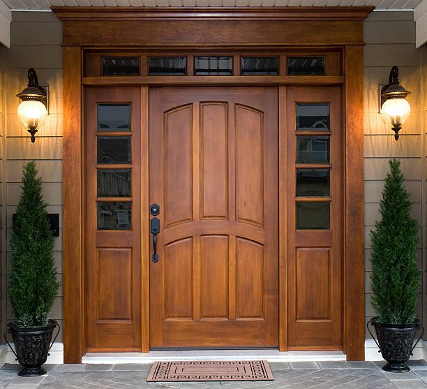 "Elegant wooden front door with sidelights and transom windows"