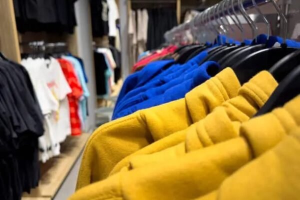 Rack of colorful hoodies in yellow, blue, and other vibrant colors