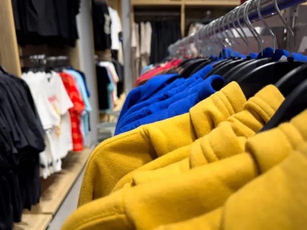 Rack of colorful hoodies in yellow, blue, and other vibrant colors