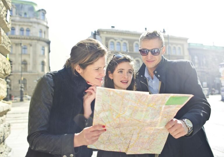 Group of tourists looking at a city map outdoors